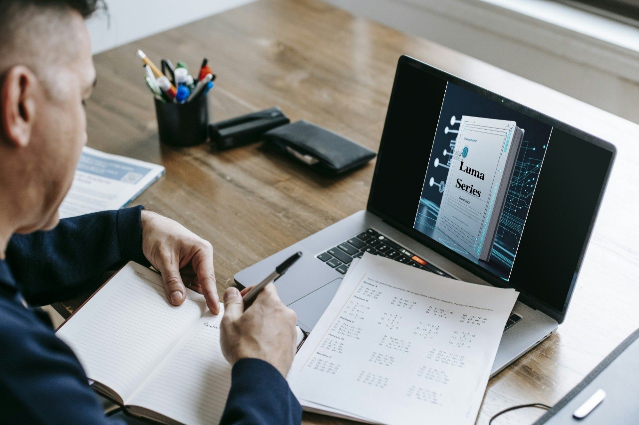 Person working at a desk with a laptop and documents